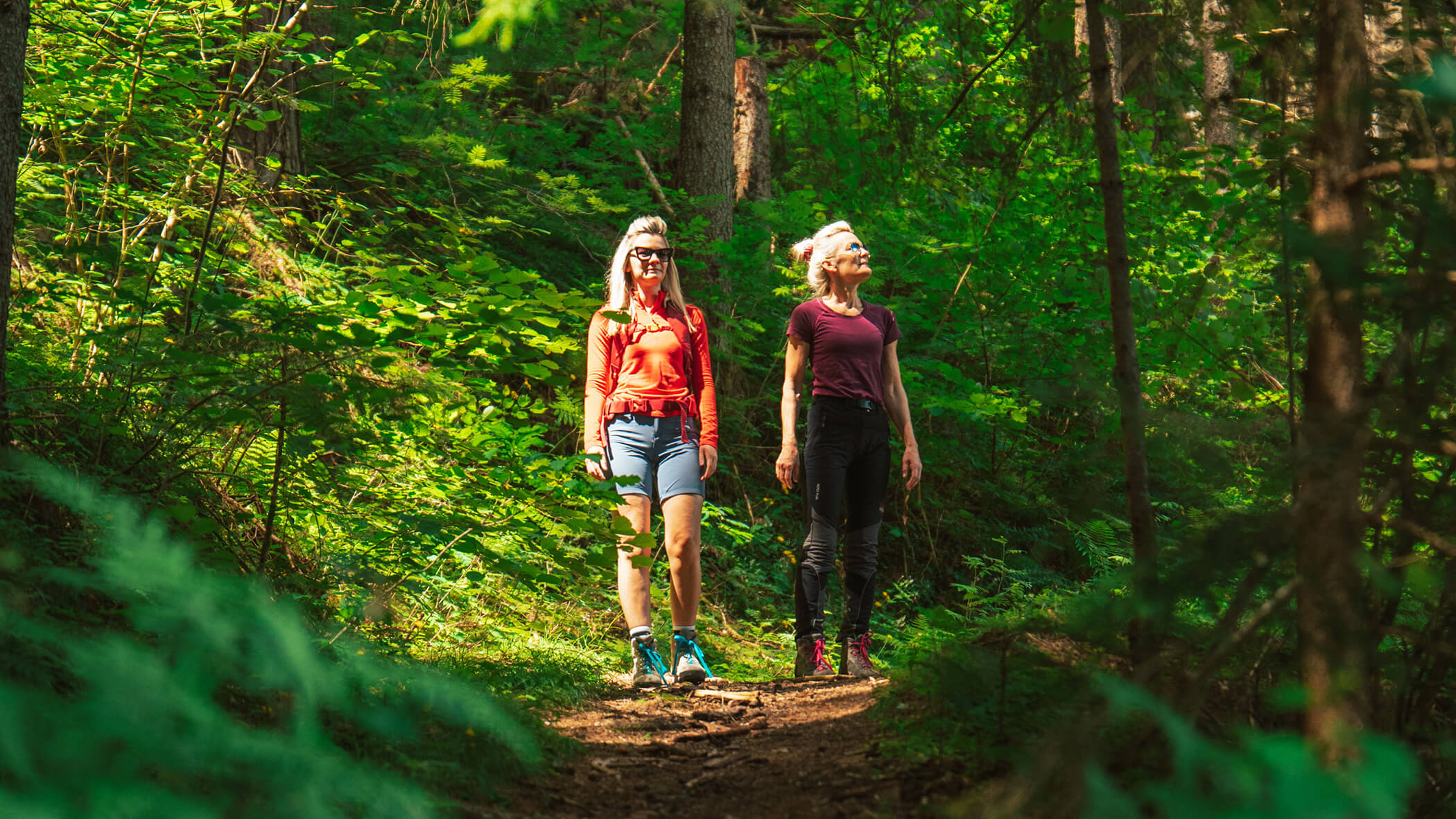 Zwei Frauen beim Wandern inmitten der Wälder - Oberplunerhof