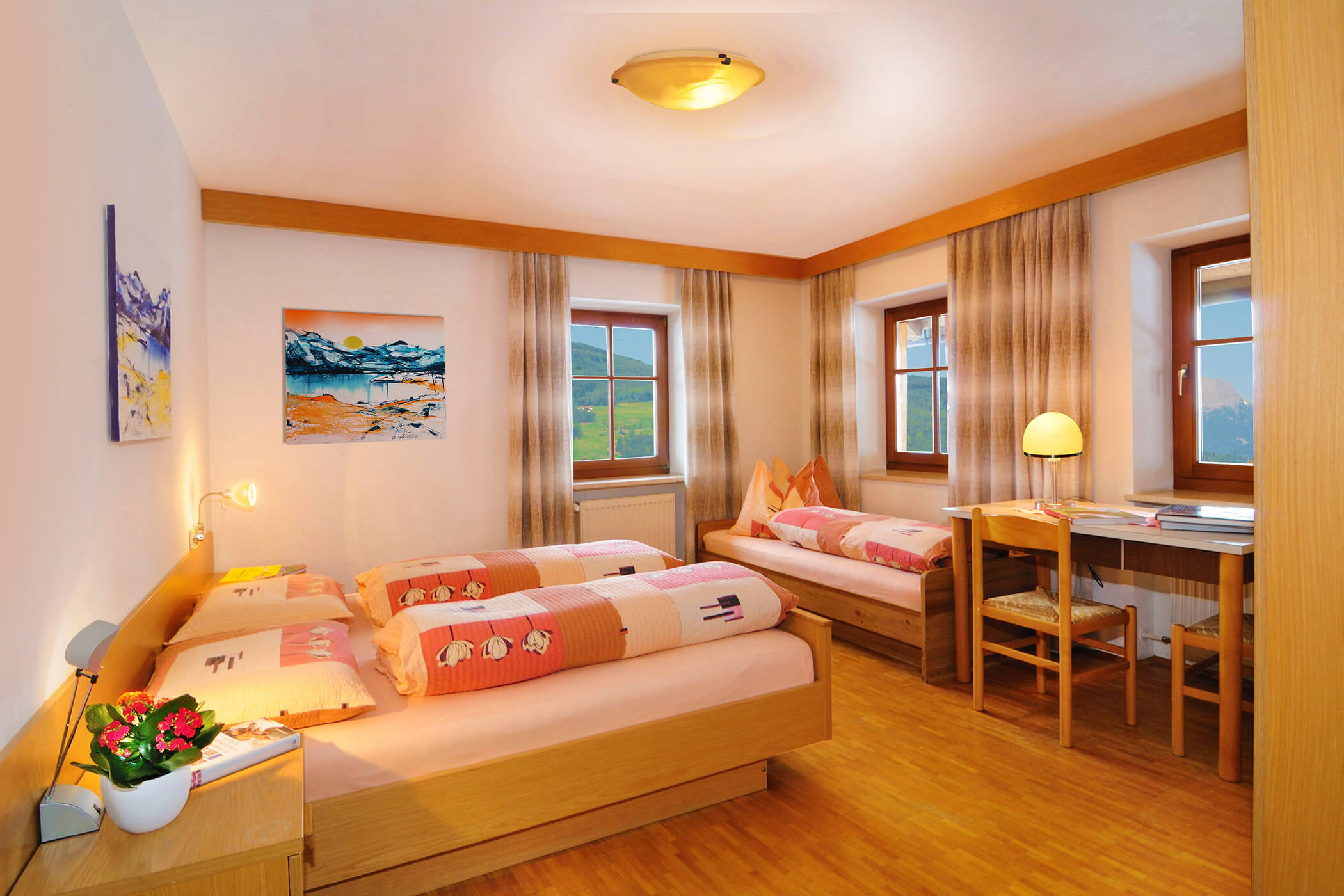 Schlafzimmer im Apartment Panorama am Radmüllerhof mit Doppelbett und Einzelbett - Oberplunerhof